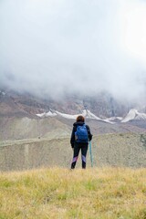 The girl and the mountain A tourist stands in front of a mountain. beautiful natural scenery