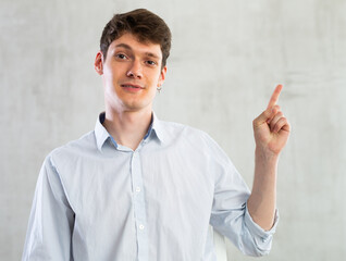 Positive man pointing with his hand at something - advertising concept