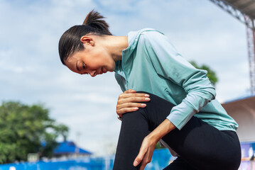 Close up asian woman runner athlete with muscle pain. Woman massaging Stretching, trauma injury...