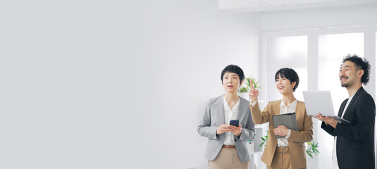 画面を見ながら話すビジネスパーソンのグループ