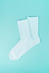 Pair of white socks on blue background. Mock up, template, flat lay