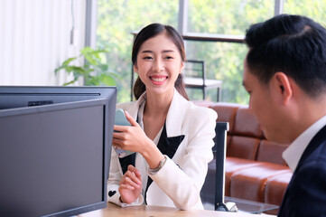 Businessman and female employee sitting and working happy smile business idea.