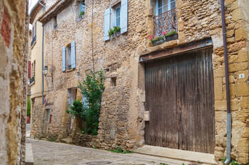Fototapeta na wymiar Ancient residential district with historic architecture and charming alleys of famous wine making village of Chateauneuf-du-Pape near Avignon, Provence-Alpes-Cote d'Azur, France. Medieval buildings