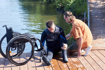 Full length portrait of man with disability preparing to perform water sports with adaptive equipment