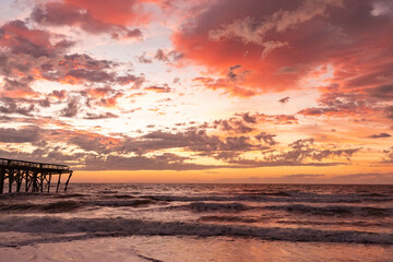 Fototapeta na wymiar Sunrise over the Pawley's Island fishing Pier one week after half the pier was washed out to sea by Hurricane Ian