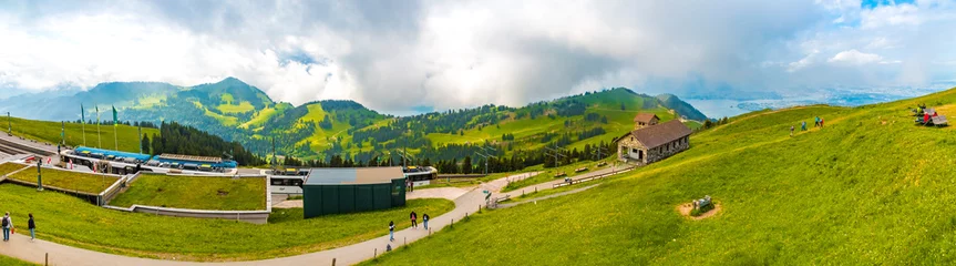Tuinposter Large panorama of the beautiful mountainous landscape with the cogwheel railway station and the Regina Montium mountain chapel on the famous Mount Rigi Kulm, the Queen of the Mountains. © H-AB Photography