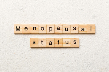 menopausal status word written on wood block. menopausal status text on cement table for your desing, concept