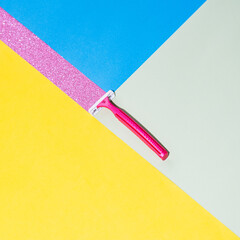 The razor leaves a trace in the form of a pink sparkles. Colorful background, minimal creative concept - 640220902