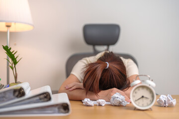 Stressed woman having Tired and Sleepy while working, female businesswoman having headache at office, Exhausted woman with documents folder stack and clock at home late night. Overworked and Overtime