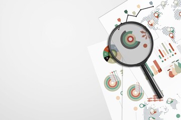Fototapeta premium Business graphs and magnifying glass on desk