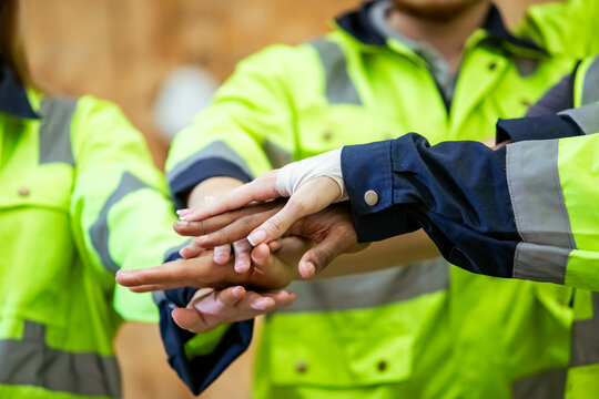 Team engineering and foreman connect join hands successful projects, Stack of hands, Teamwork partner concept. warehouse diversity worker handshake agreement.