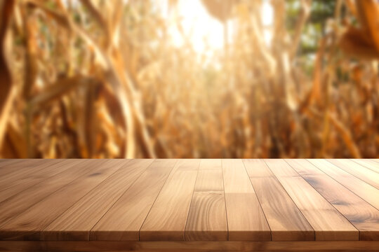 Wooden table with cornfield background at sunset