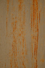 Orange rusty surface of old iron. Corroded metal background. Rusted white painted metal wall. Rusty metal background with streaks of rust. Rust stains. The metal surface rusted spots.