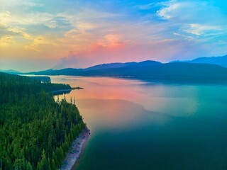 Aerial view of Hungry Horse Reservoir with forest fire in the distance located in the Flathead...