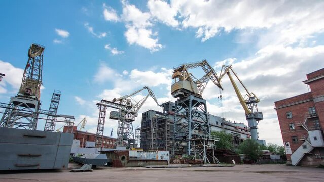 The construction of a large ship on a shipyard with cranes timelapse hyperlapse. A fragment of the case in the workshop of the plant. Metal frame during assembly