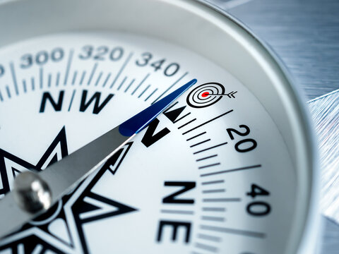 Business goals direction, guidance, mission plan, navigate strategy, achievement objectives and success concepts. Close-up target dart icon on modern round white compass with metalic silver arrow.