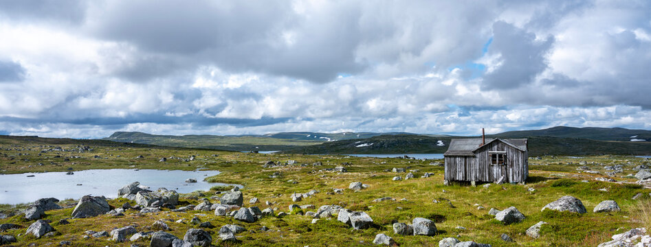old barn and rocks on plain of hardangervidda in norway