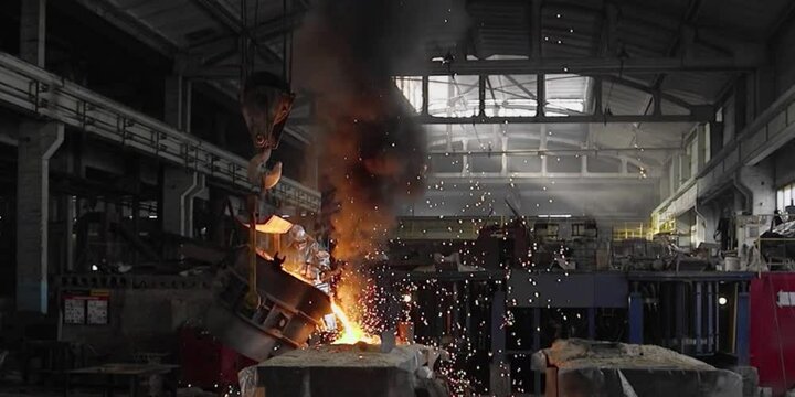 Liquid iron molten metal pouring in container, industrial metallurgical factory, foundry cast, heavy industry 
