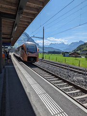 Naklejka premium train on railway station scenic Switzerland