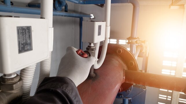 Engineer check the pressure control switch installed on the pipe water line.
pressure control on plumbing system water treatment plants.