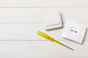 Electrician equipment on a wooden background with copy space.Top view.Electrician tool set.Multimeter, tester,screwdrivers,cutters,duct tape,lamps,tape measure and wires.Flet lay.Concept building © Avocado_studio