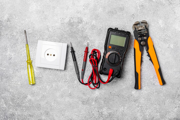 Electrician equipment on marble background with copy space.Top view.Electrician tool set.Multimeter, tester,screwdrivers,cutters,duct tape,lamps,tape measure and wires.Flet lay. Construction concept. © Avocado_studio