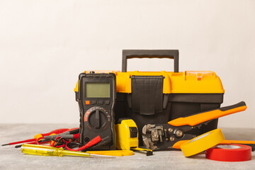 Electrician equipment on marble background with copy space.Top view.Electrician tool set.Multimeter, tester,screwdrivers,cutters,duct tape,lamps,tape measure and wires.Flet lay. Construction concept. © Avocado_studio