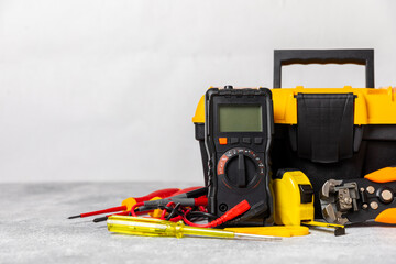 Electrician equipment on marble background with copy space.Top view.Electrician tool set.Multimeter, tester,screwdrivers,cutters,duct tape,lamps,tape measure and wires.Flet lay. Construction concept. © Avocado_studio