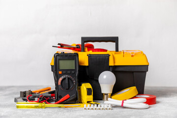 Electrician equipment on marble background with copy space.Top view.Electrician tool set.Multimeter, tester,screwdrivers,cutters,duct tape,lamps,tape measure and wires.Flet lay. Construction concept. © Avocado_studio
