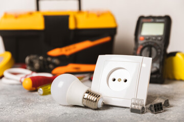 Electrician equipment on marble background with copy space.Top view.Electrician tool set.Multimeter, tester,screwdrivers,cutters,duct tape,lamps,tape measure and wires.Flet lay. Construction concept. © Avocado_studio
