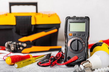 Electrician equipment on marble background with copy space.Top view.Electrician tool set.Multimeter, tester,screwdrivers,cutters,duct tape,lamps,tape measure and wires.Flet lay. Construction concept. © Avocado_studio