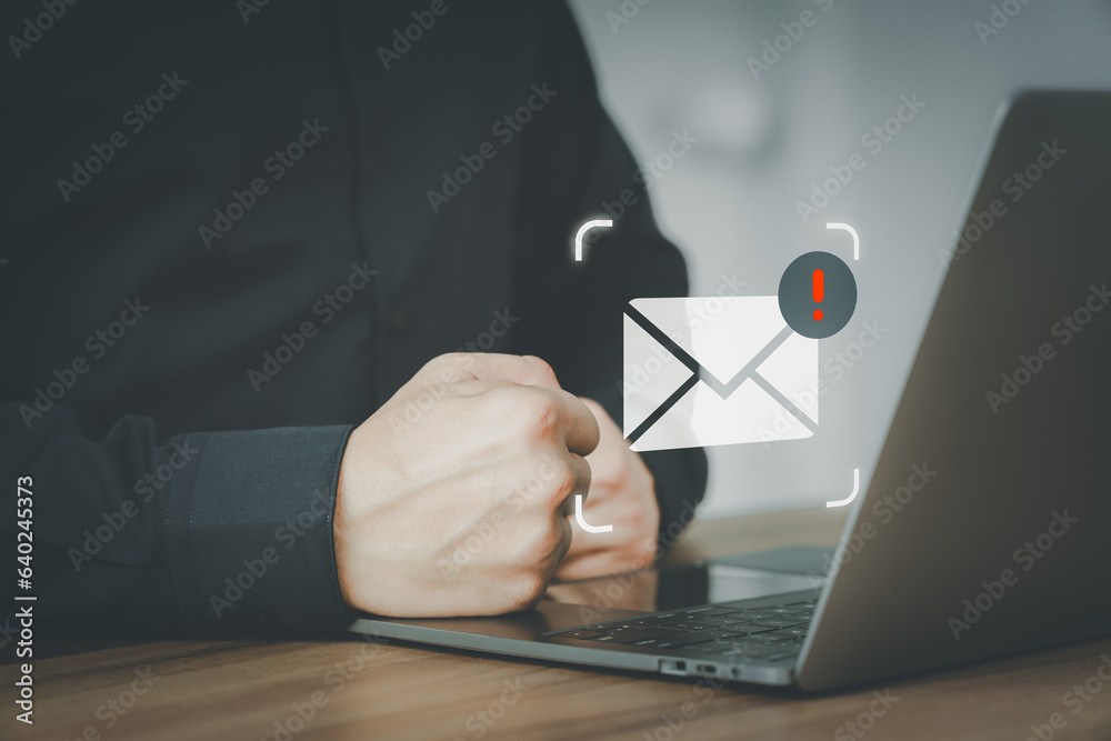 Poster male hand using a computer laptop with an email icon, email alert with a caution warning sign for no