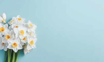 A narcissus flowers bouquet on a pastel blue background with empty copyspace. Mother's Day concept. Created by generative AI