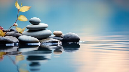 Zen stones symmetrically aligned against calm water. 