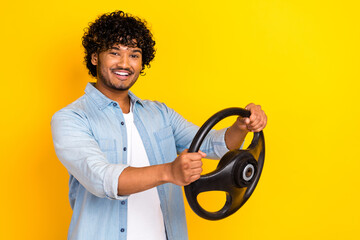 Profile photo of nice cheerful guy toothy smile hands hold steering wheel empty space isolated on...