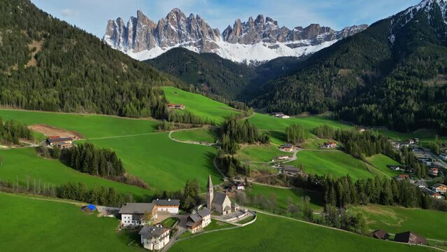 Spring landscape with shurch in Santa Magdalena village, Italian Dolomites Alps, in South Tyrol, Val di Funes, Italy, 4k