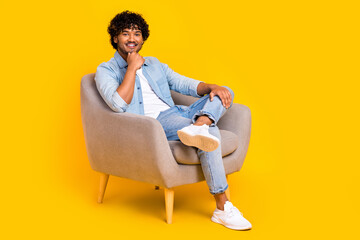 Full size photo of thoughtful smart man dressed denim shirt sit in armchair arm on chin think...
