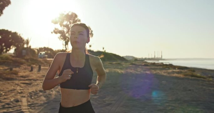 Wellness at Dawn: Empowering Morning Jog of Sporty Woman Embracing Active Lifestyle amidst Sunrise. High quality 4k footage