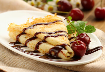 crepe pancake with chocolate sauce and berries for dessert