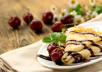 crepe pancake with chocolate sauce and berries for dessert
