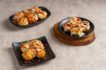 Takoyaki is a ball-shaped Japanese snack made of a wheat flour-based batter and cooked in a special molded pan