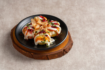 Takoyaki is a ball-shaped Japanese snack made of a wheat flour-based batter and cooked in a special molded pan