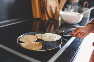 Cooking breakfast, pancakes in a pan