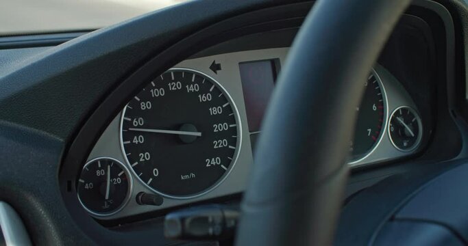 A close-up of the speedometer of a car driving on the road. the concept of a trip around the city or on a trip. High quality 4k footage