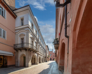 Alba, Langhe, Piedmont, Italy - via Cavour with medieval arcades and the Town Hall in the...