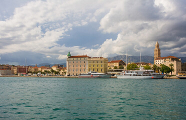 Naklejka premium The waterfront of the historic coastal city of Split in Dalmatia, Croatia. The Cathedral of Saint Domnius bell tower is far right and the Harbour Master's Office centre
