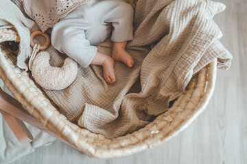 Feet of a newborn baby in a cradle, top view, space for text