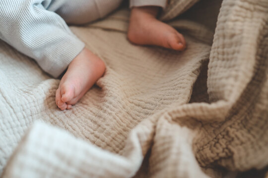 Feet of a newborn baby in a cradle close-up