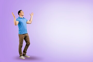 handsome young sporty man posing on color background