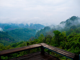 A beautiful scenic view with green mountains and fog at 